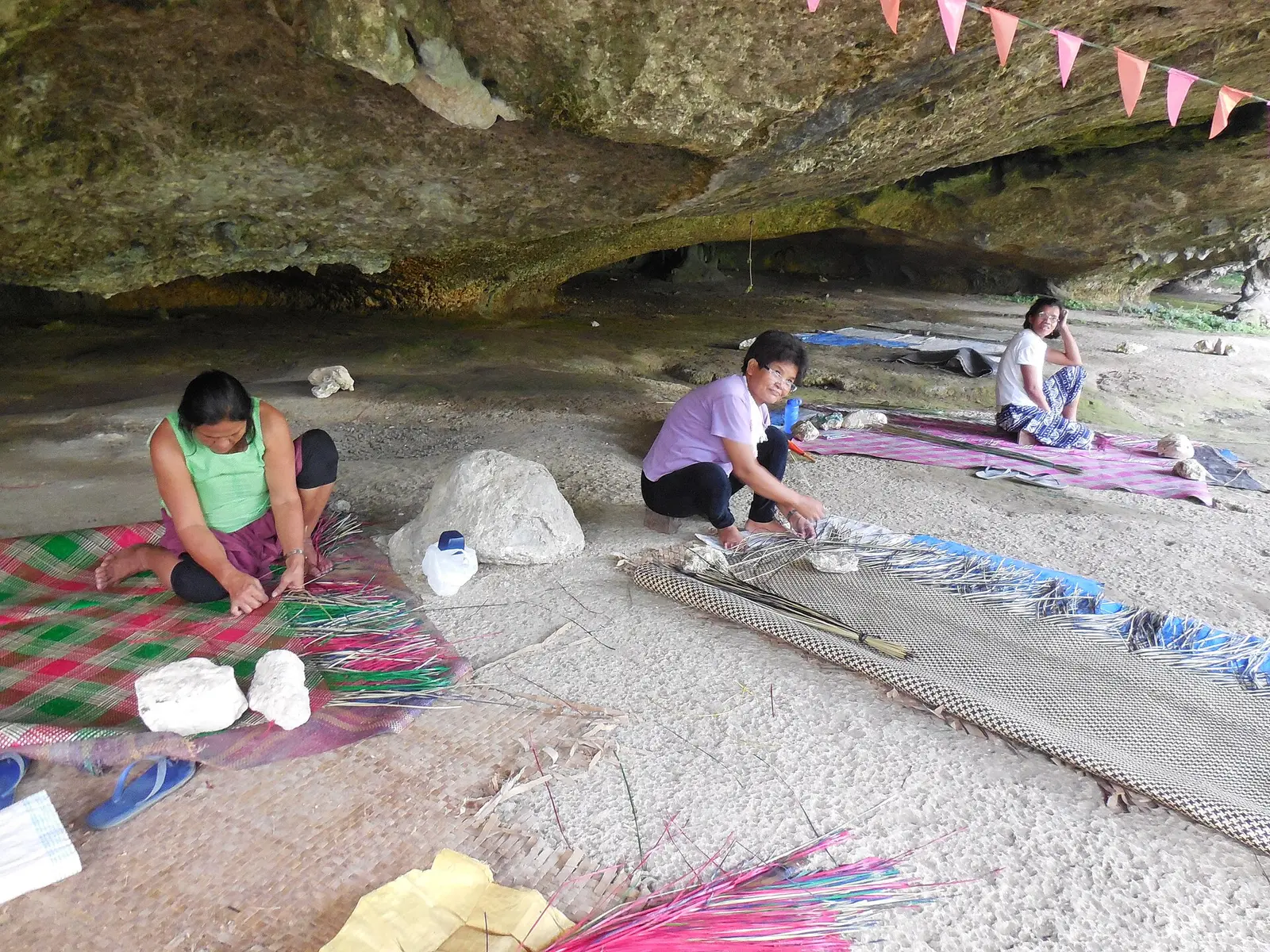 A paraglara weaving a banig mat at Saob Cave in Basey, Samar, Philippines